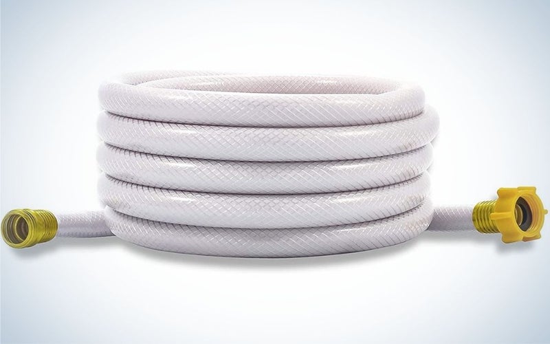 A big white long garden hose with gold heads in two sides.