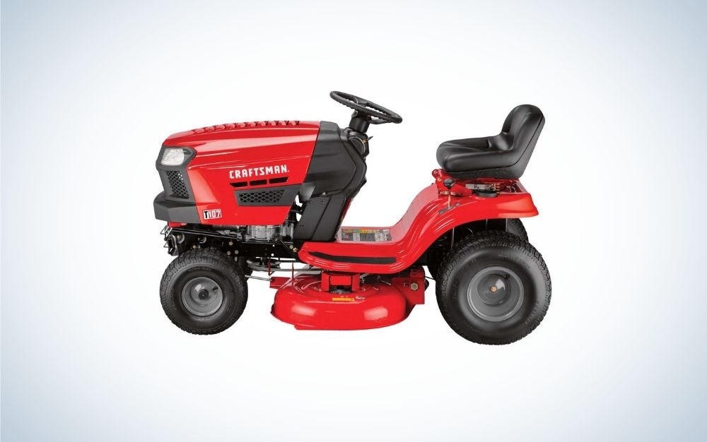 A red lawn mower with 4 black wheels and a black seat as well.