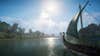 A Viking longship sailing down an English river in Assassin's Creed: Valhalla.
