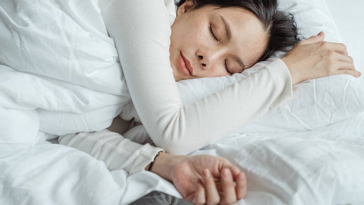 Person sleeping under weighted blanket