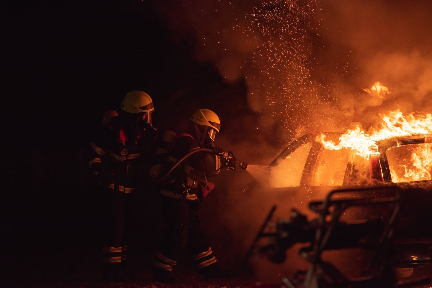 Stock images of a car fire and firefighters. 