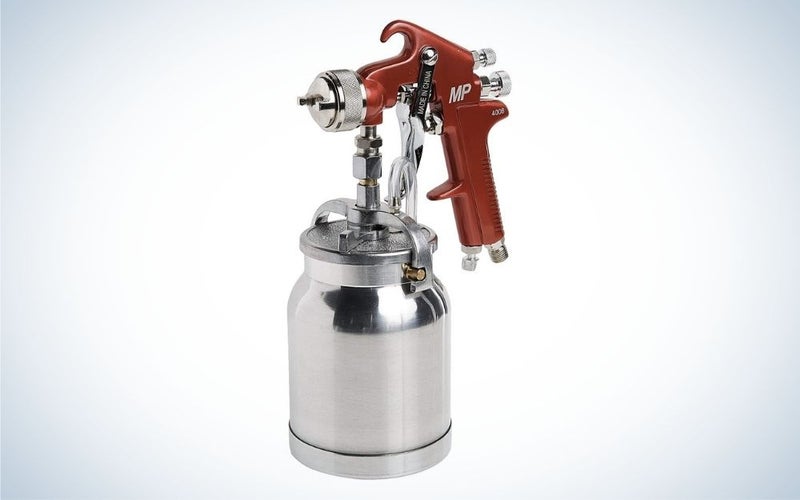 Paint spray gun with a red handle and a cup