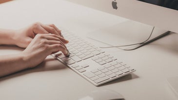 hands on a mac keyboard