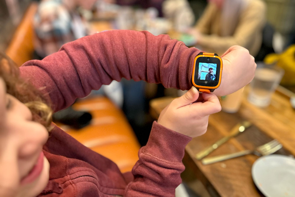 XPLORA XGO 3 smartwatch on a kid's wrist in a restaurant