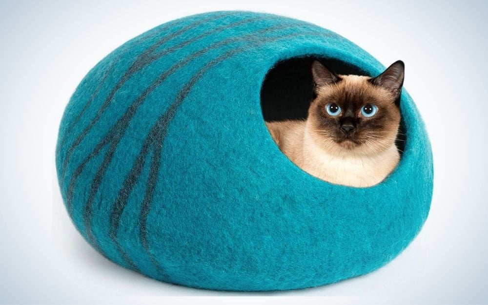 Large, aquamarine, wool cat bed cave with a blue-eye cat in it