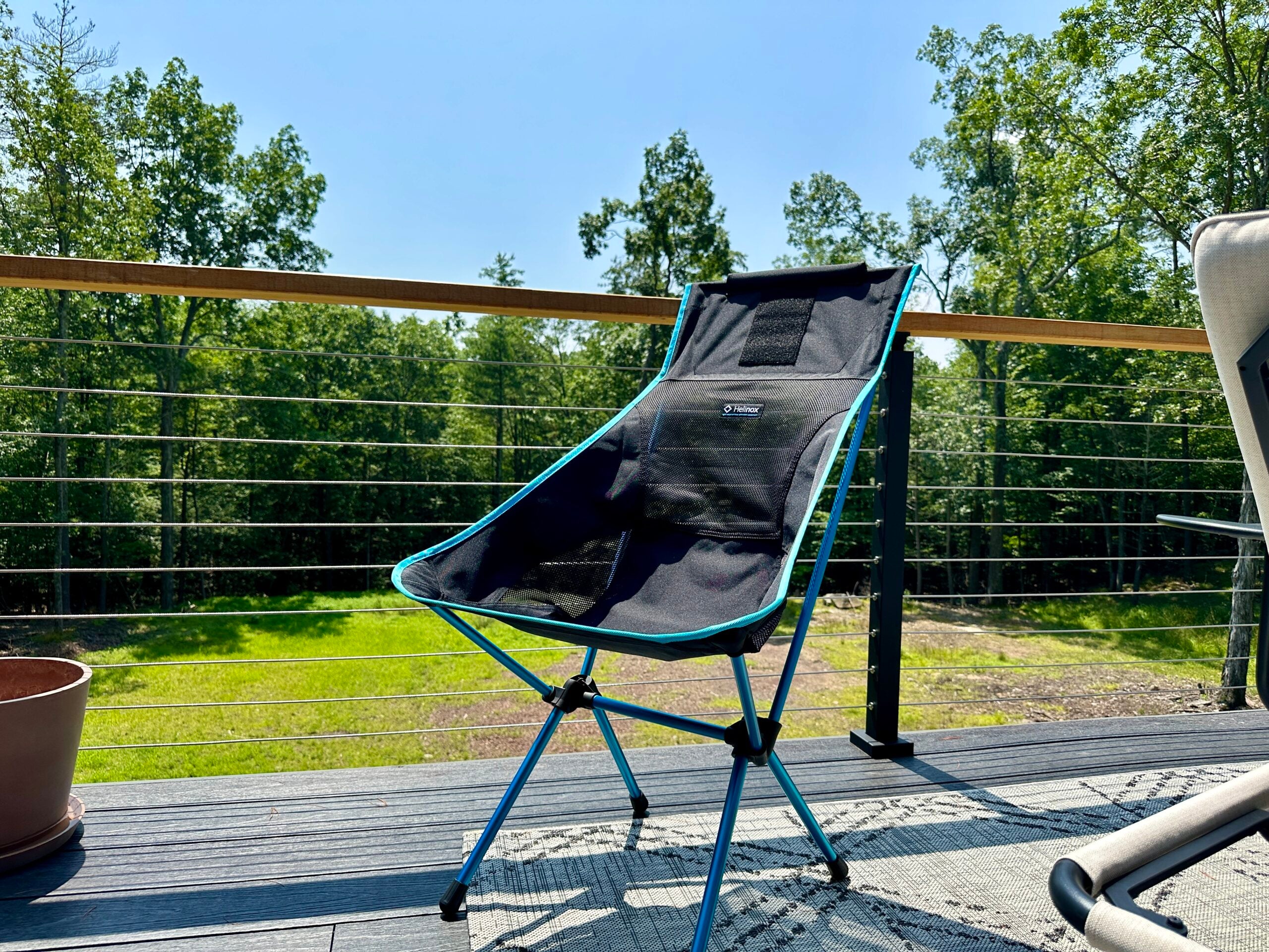 helinox chair on a deck with forest behind