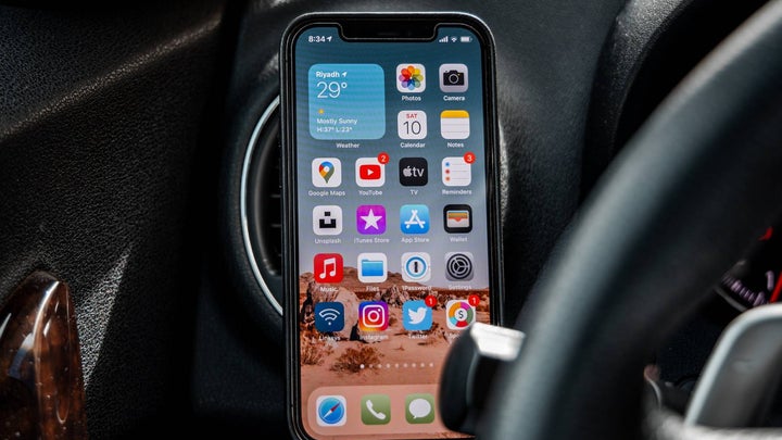 iPhone beside steering wheel in car