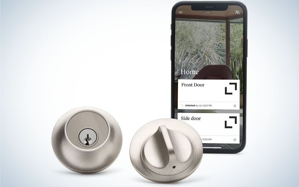 Round, satin nickel smart lock and a smartphone controlling the lock