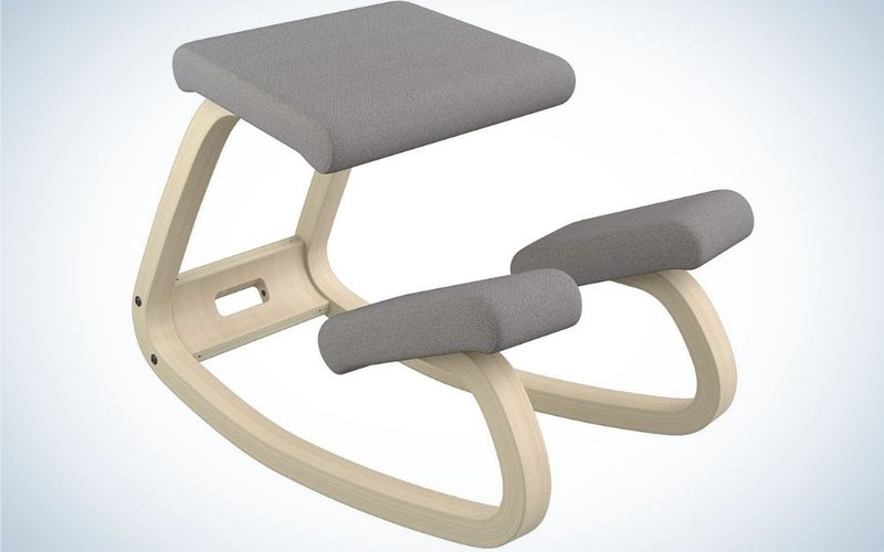 A beige kneeling chair with grey seats and two supportive pieces of the chair to make the best ergonomic chair.