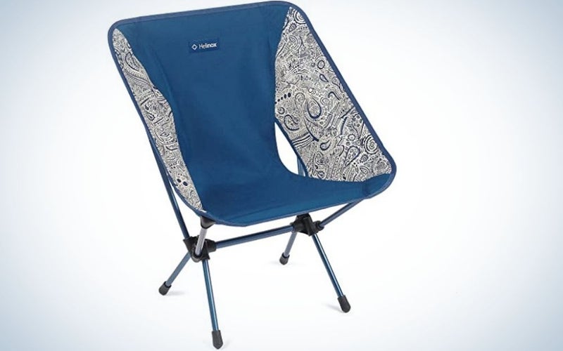 A portable blue and white chair with four metallic legs.