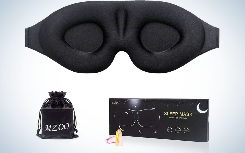A pair of eye sleep mask all black to cover the eyes when we sleep, a small box under it and small bag too.
