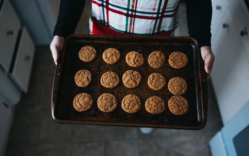 Person holding baking tray of cookies