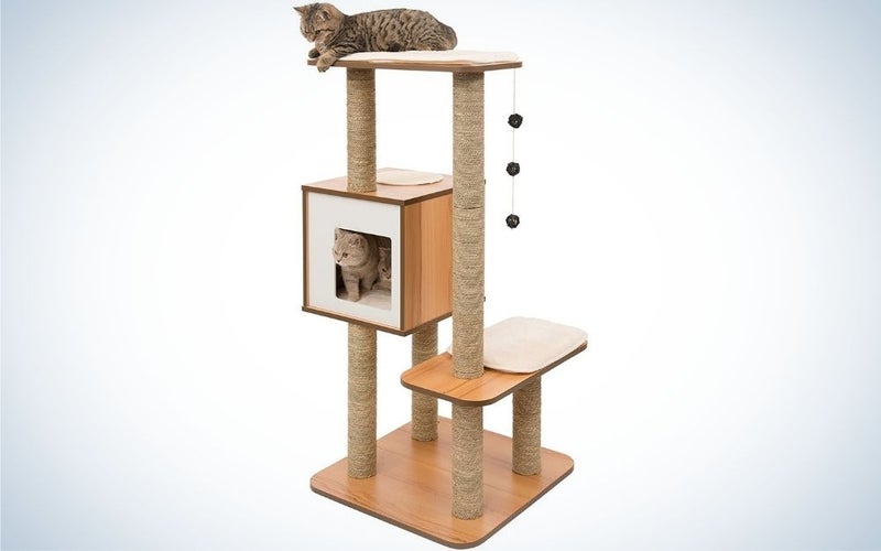 A large cat tree with a wooden material and with three floors, two just to stand or sit uncovered, and second floor is like a small box with an open door.