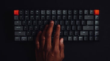 Black hands at a wireless keyboard
