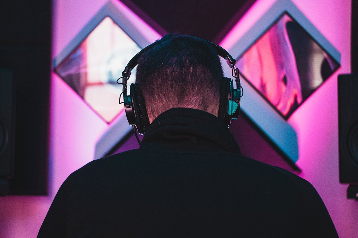 Person from behind wearing headphones.