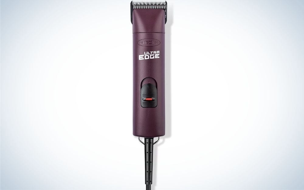 A purple machine for trimming dog hairs as well as a black plug.