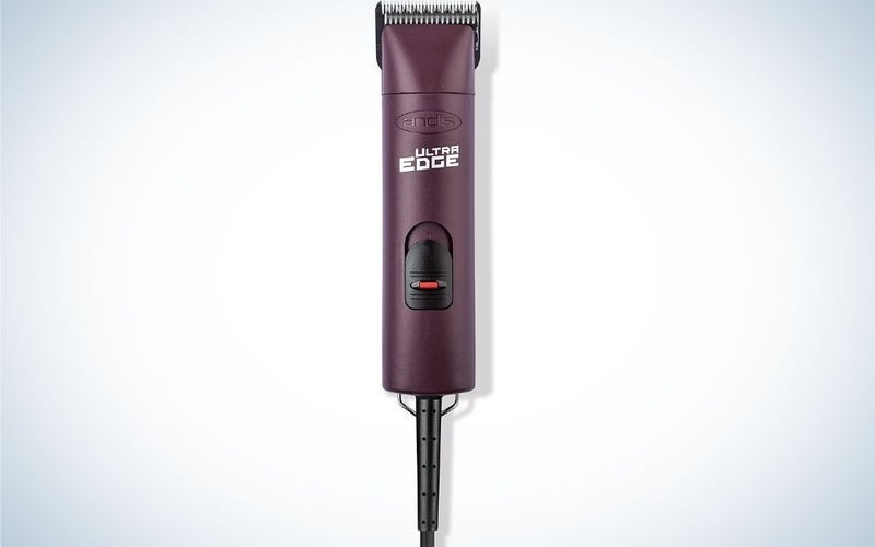 A purple machine for trimming dog hairs as well as a black plug.