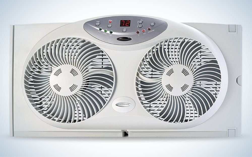 A large all-gray fan with two twin reversible airflow blades centered on a red button and numbers on it.