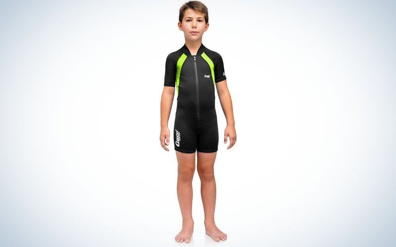 A young child wearing a black wetsuit with yellow stripes on it, which was with short arms and tracksuits.