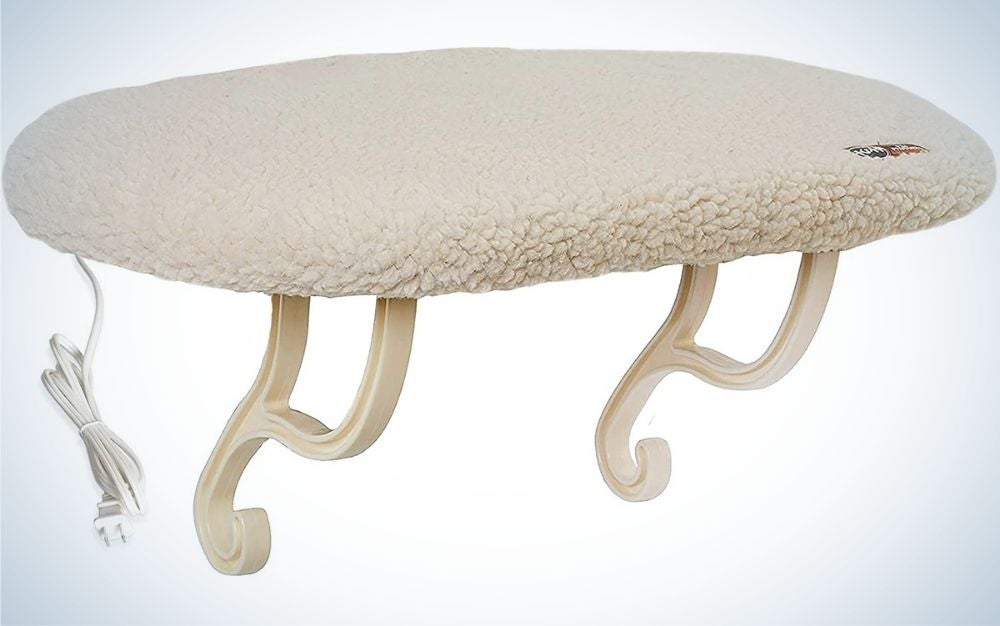 A light beige cat window perch with a thick wool-like backrest, as well as two arched legs to support this perch window.