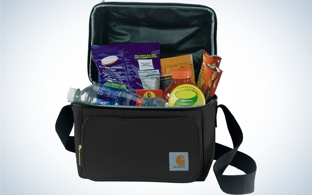 A small square shape black lunch bag with a zipper at the bottom of it and full with items in it.