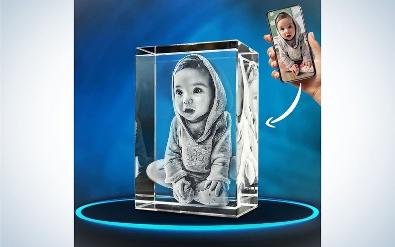 A photo reflected in a transparent glass box and with a photo of a small child inside.