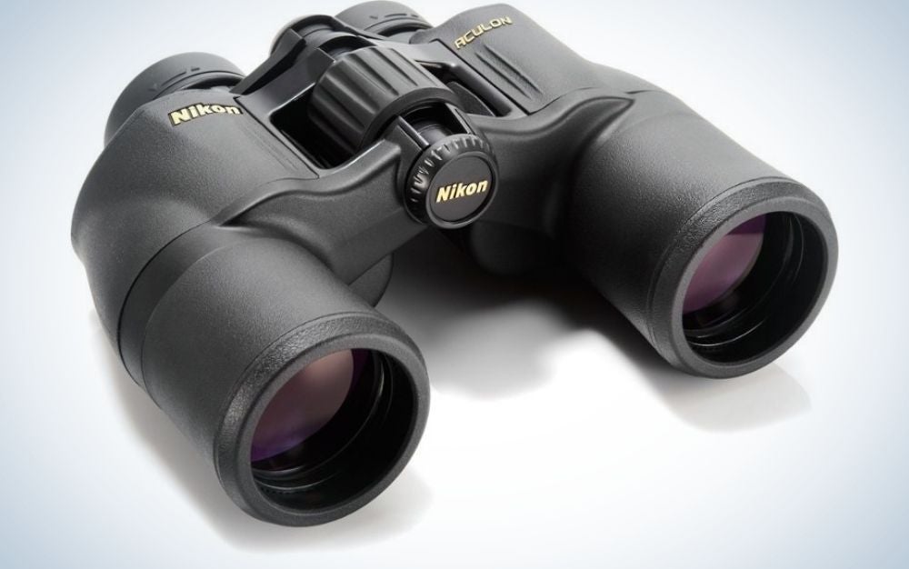 A pair of professional binoculars all black and with dark glass lenses and in large round shapes.