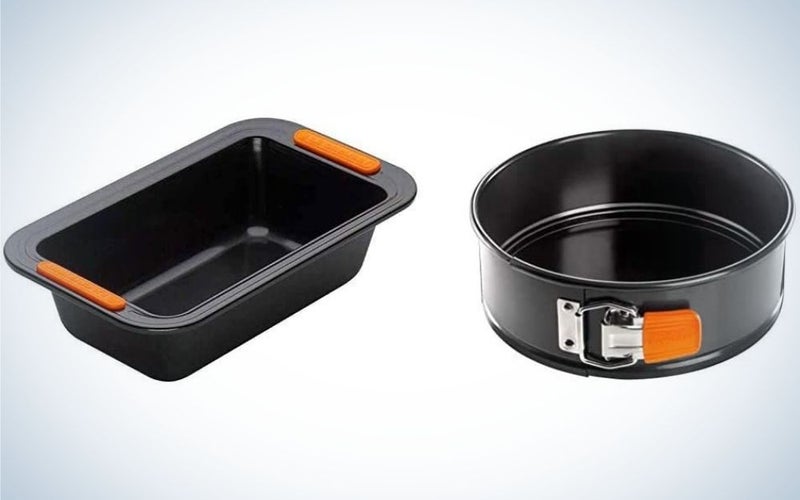 Two pans with different shapes where one is round and the other in a rectangular shape and both with black color and with orange clip.