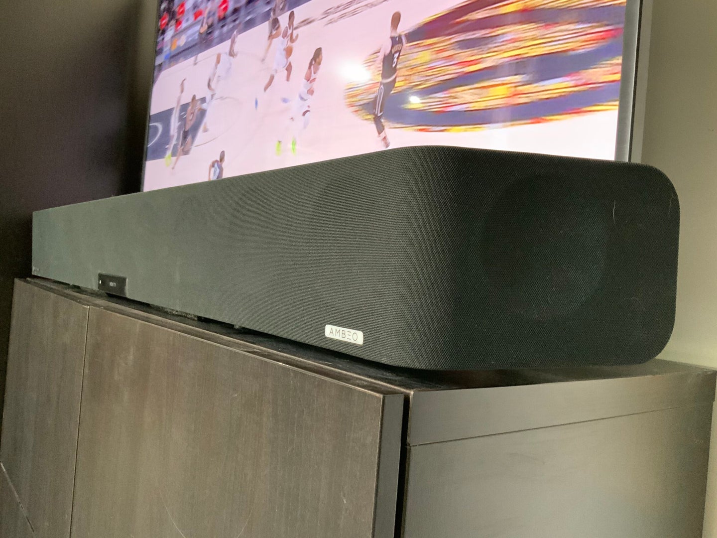 The Sennheiser AMBEO Soundbar in front of a flatscreen TV