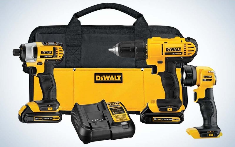 A yellow and black Dewalt tool bag with a cordless drill, impact driver, LED light, and battery charger in the foreground.