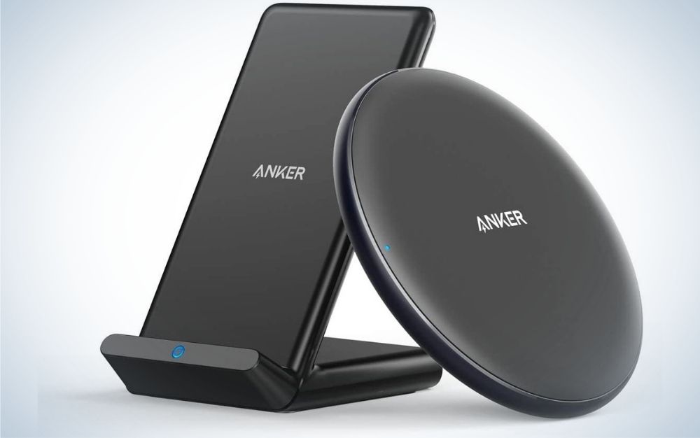 Two chargers for cordless phones which are all black and one in a circular shape and the other in a rectangular shape.