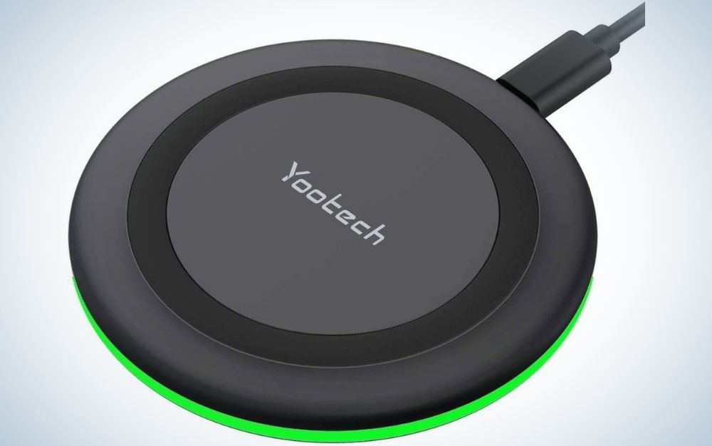 An all-black cordless charger with a circular shape and a life visa on the side.