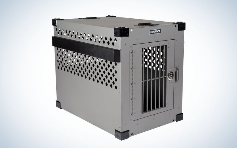 A metal dog cage with an entrance gate and the top of the cage with a few holes in it.