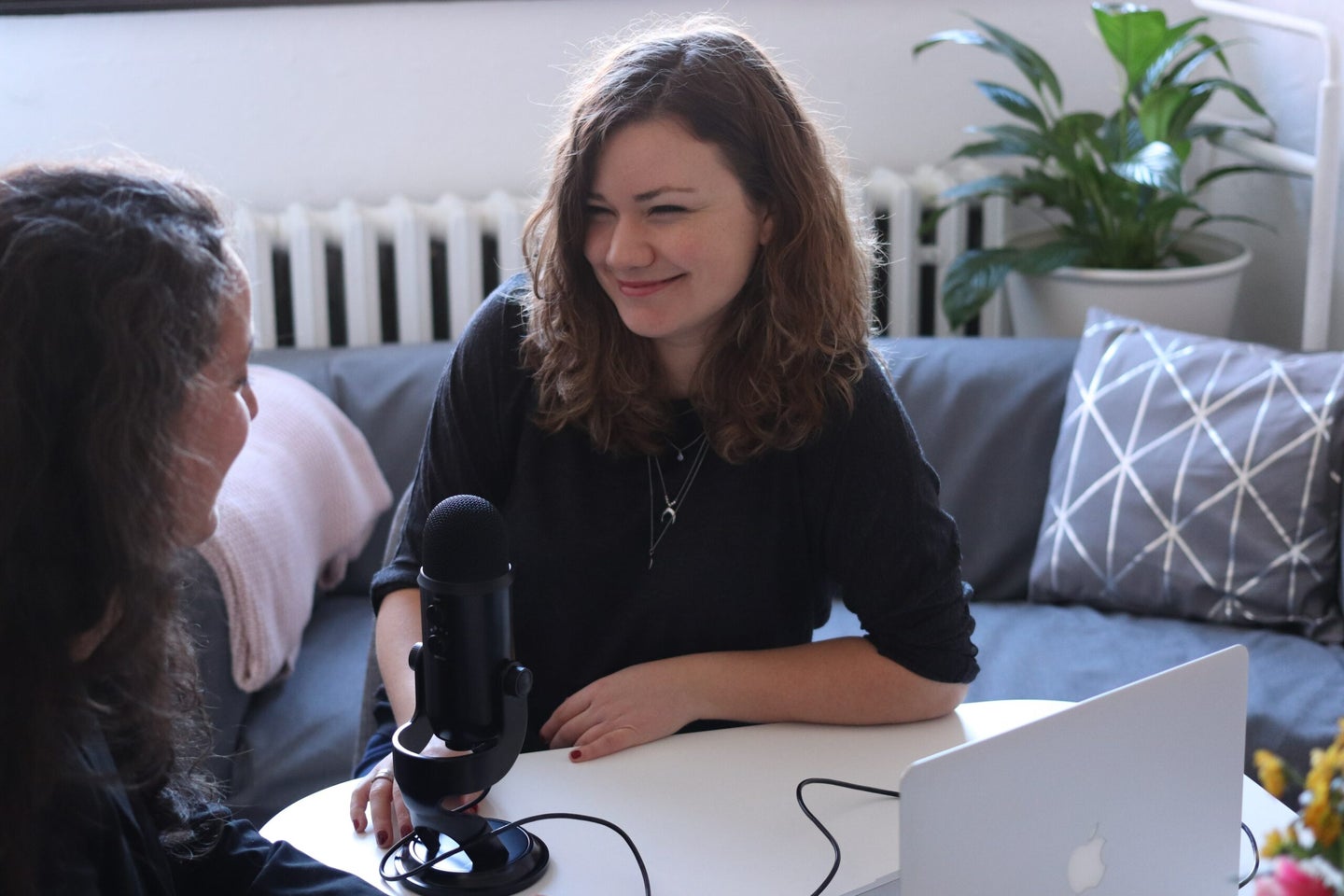 two women podcasting with a Blue Yeti