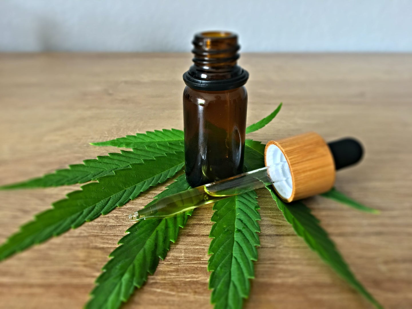 one of the best cbd oil vials on top of a marijuana leaf