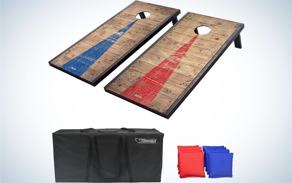 Two square wooden shapes with a blue and red stripe each of them and with a circular hole in their upper part, as well as a big black bag and some small square shapes red and blue in the shape of pillows.