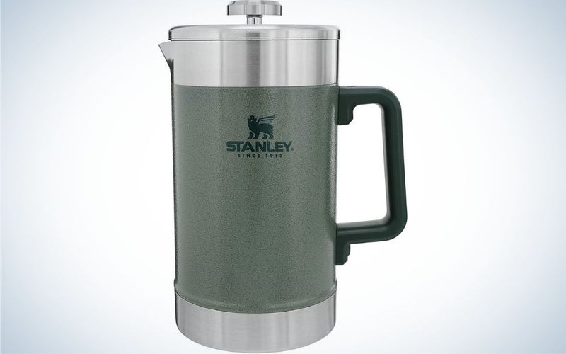 A kettle for storing the heat of coffee in it with a silver lid and a small holder, as well as a body of matte material of a gray color.