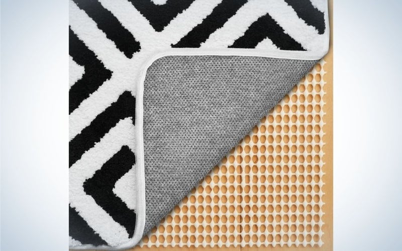 Some types of pieces on top of each other, one beige and the other on it is white with zig zag stripes black.