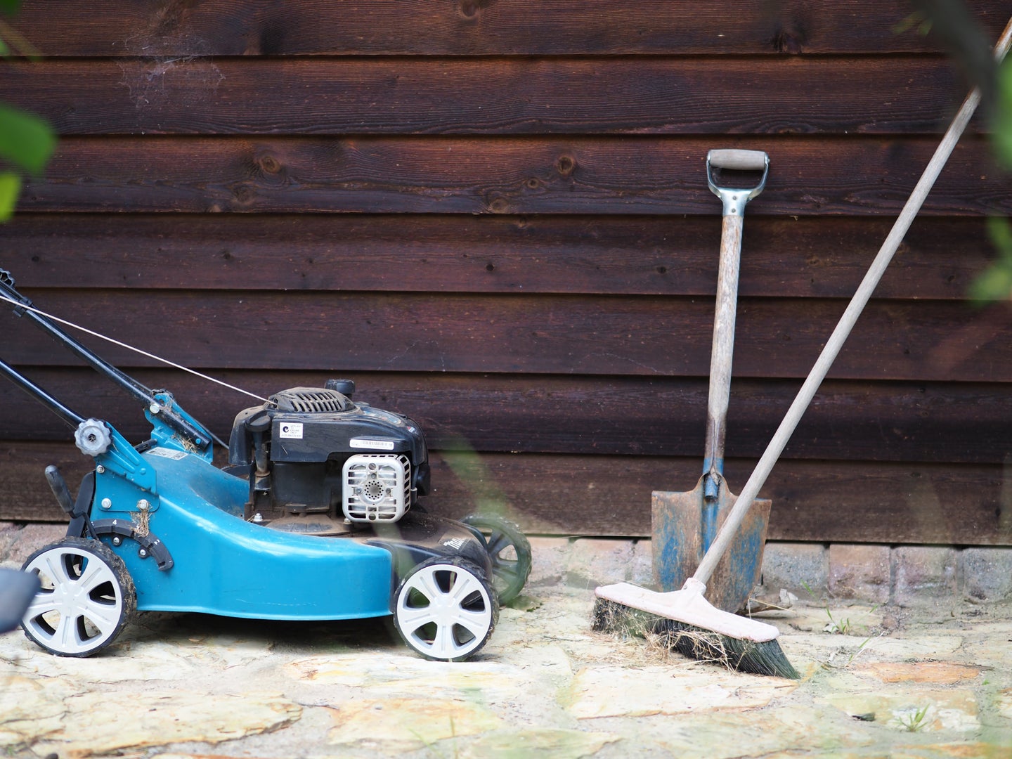 A lawnmower, which you won't really need for a ground cover lawn, with a shovel and a broom for digging up your grass lawn.