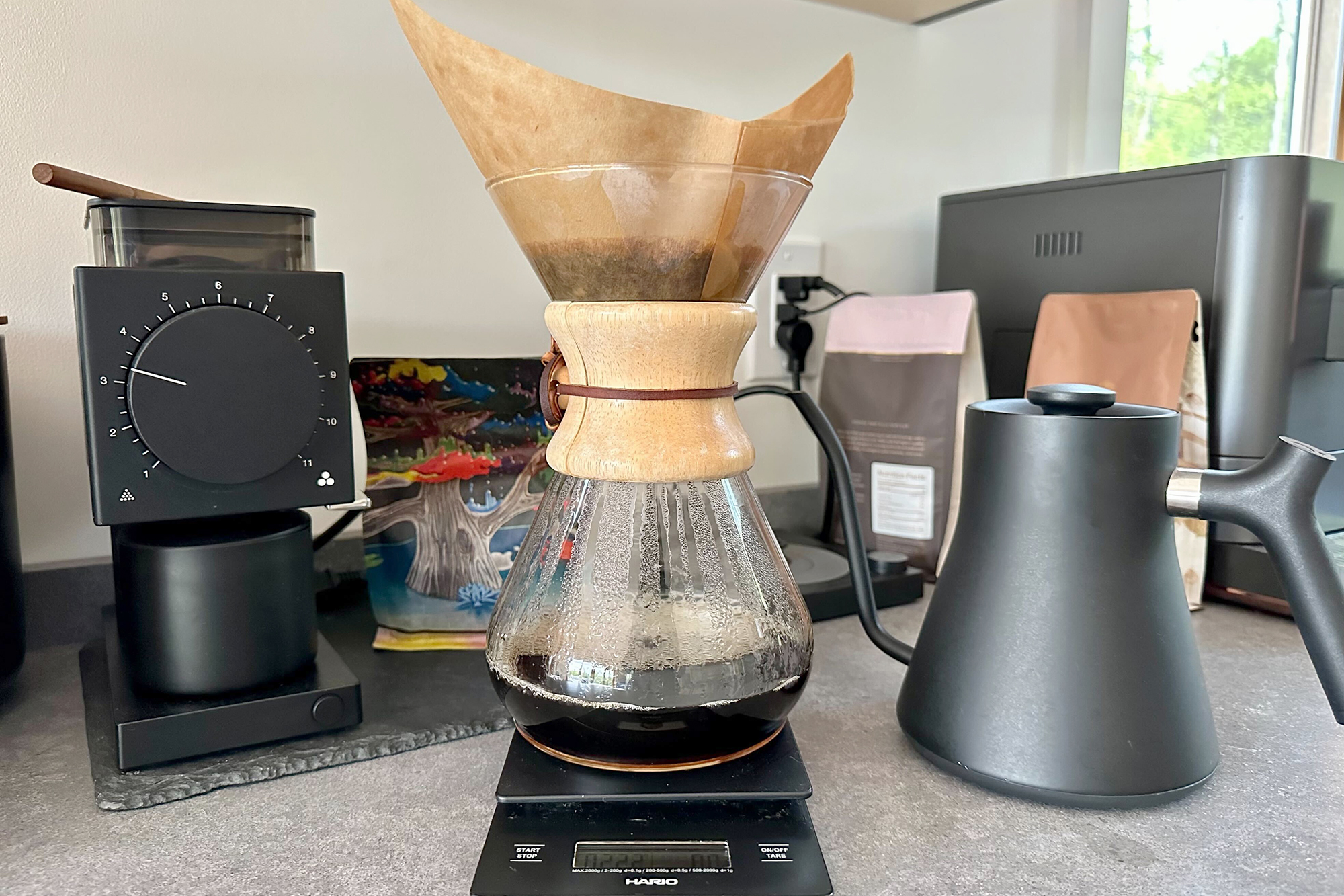 Chemex pour-over coffee maker on a scale with Fellow grinder and gooseneck kettle