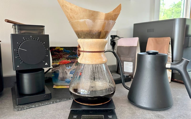 Chemex pour-over coffee maker on a scale with Fellow grinder and gooseneck kettle