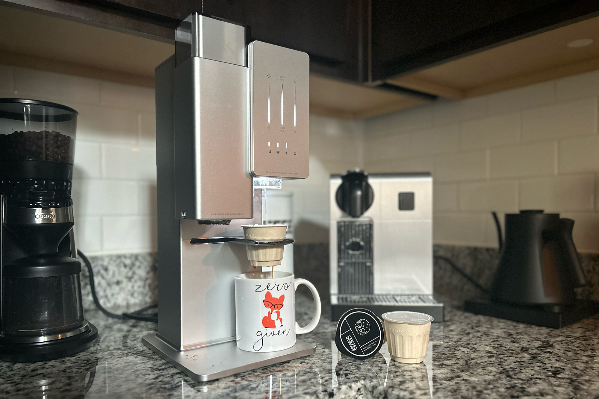 The xBloom automatic pour-over system with xPods sitting on a counter with OXO grinder, Nespresso machine, and Fellow kettle