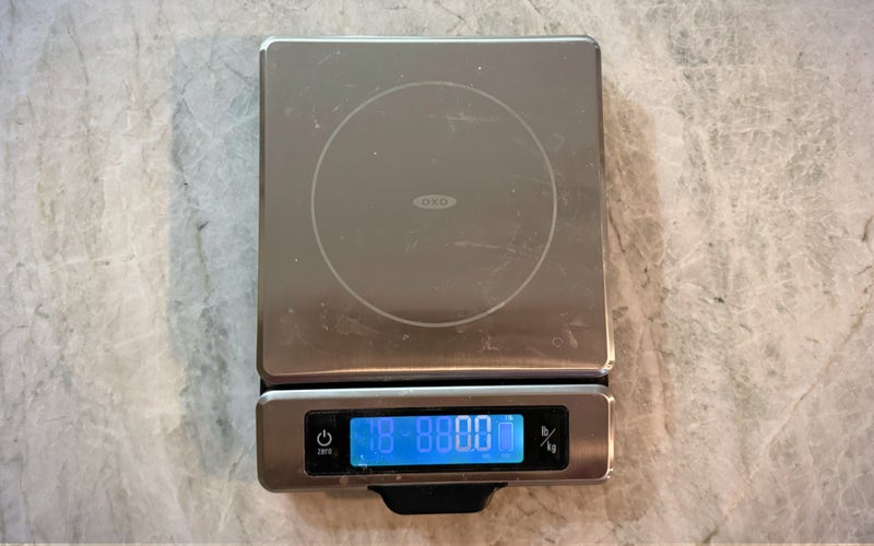 OXO Good Grips 11-Pound Stainless Steel Food Scale with Pull-Out Display on a counter.