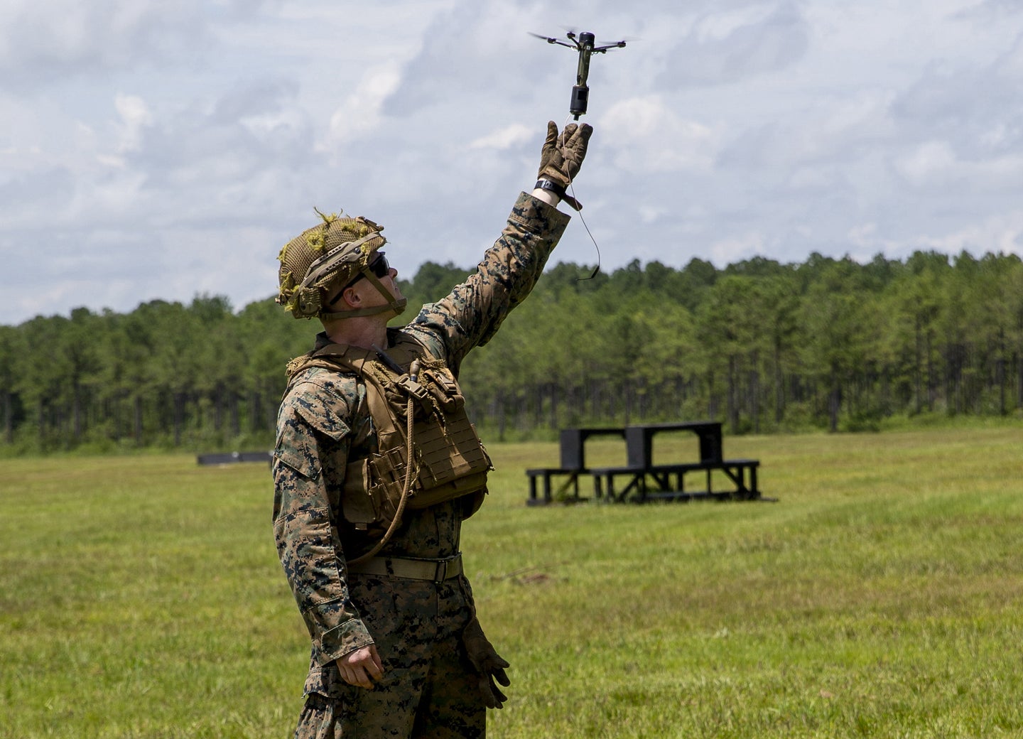 A Marine tests out a flying grenade during an exercise. 