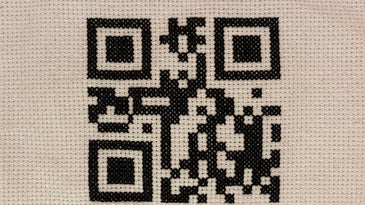 A cross-stitched QR code.