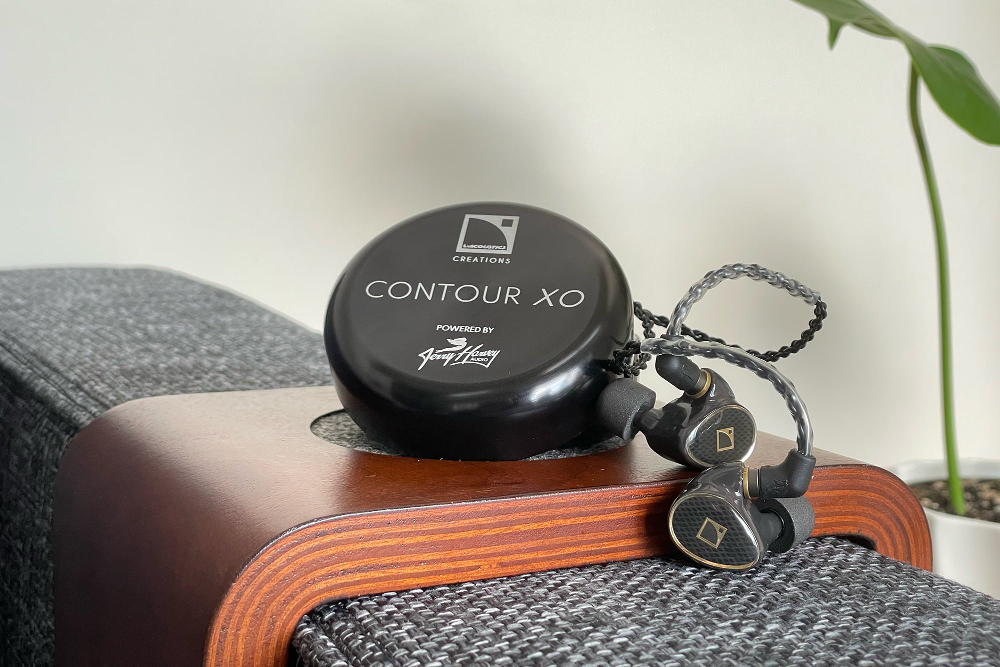 JH Audio x L-Acoustics Contour XO universal in-ear monitor siting with hockey puck case on my couch arm