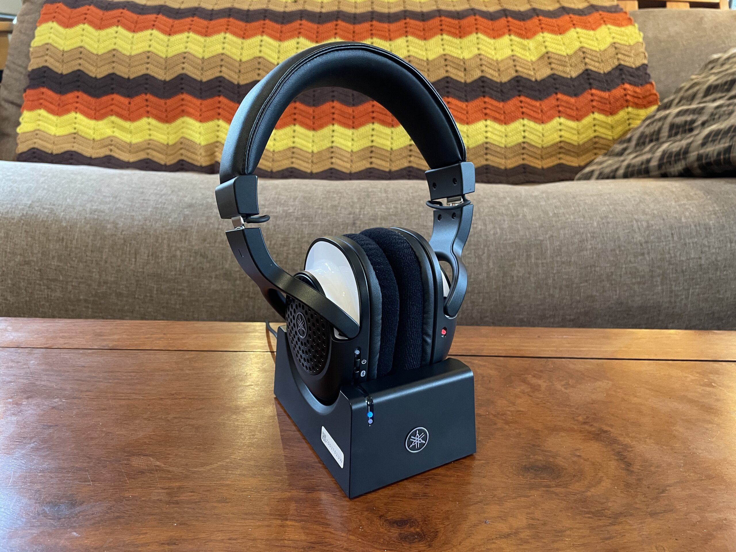 The Yamaha YH-WL500 wireless musicians headphone on a table in front of a colorful blanket