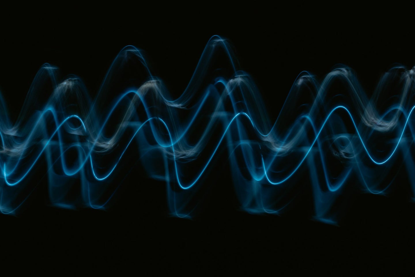 blue sine waves on a black background