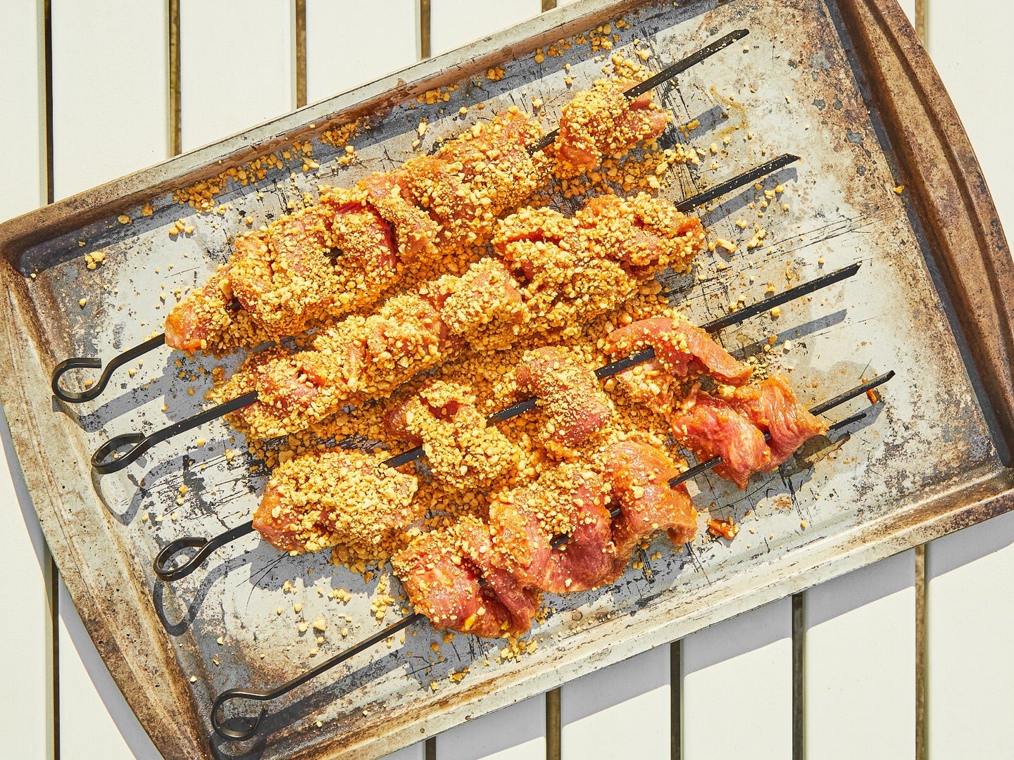 Grilled meat skewers on a baking sheet