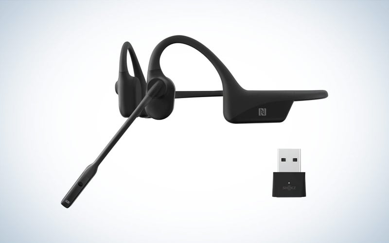 The Shokz OpenComm2 UC bone conduction headphones and USB-A adapter are placed against a white background.